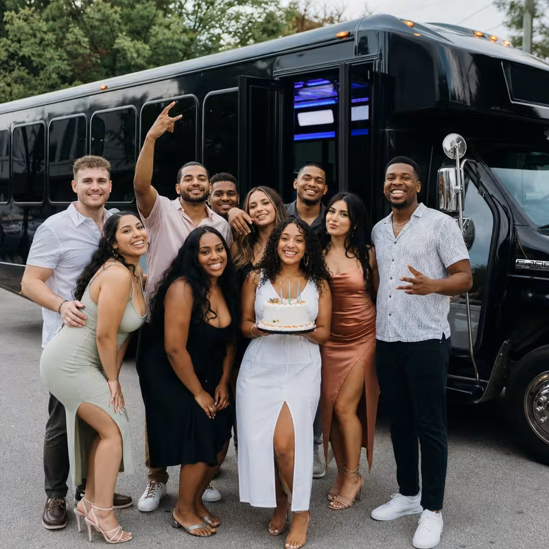 Group boarding a white charter bus for Birthday Transportation transportation in Atlanta