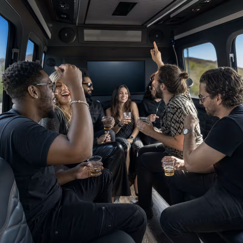 Group boarding a white charter bus for Concert Transportation transportation in Atlanta