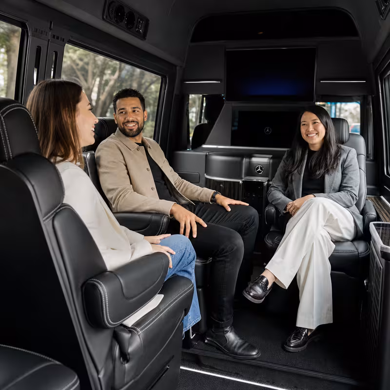 Group boarding a white charter bus for Corporate Transportation transportation in Atlanta
