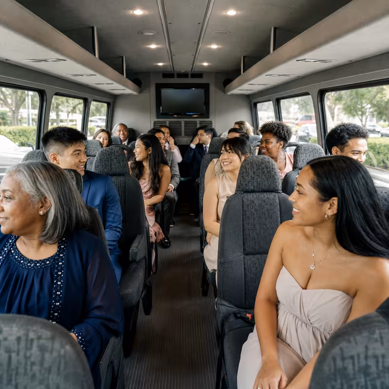 Group boarding a white charter bus for Private Event Transportation transportation in Atlanta