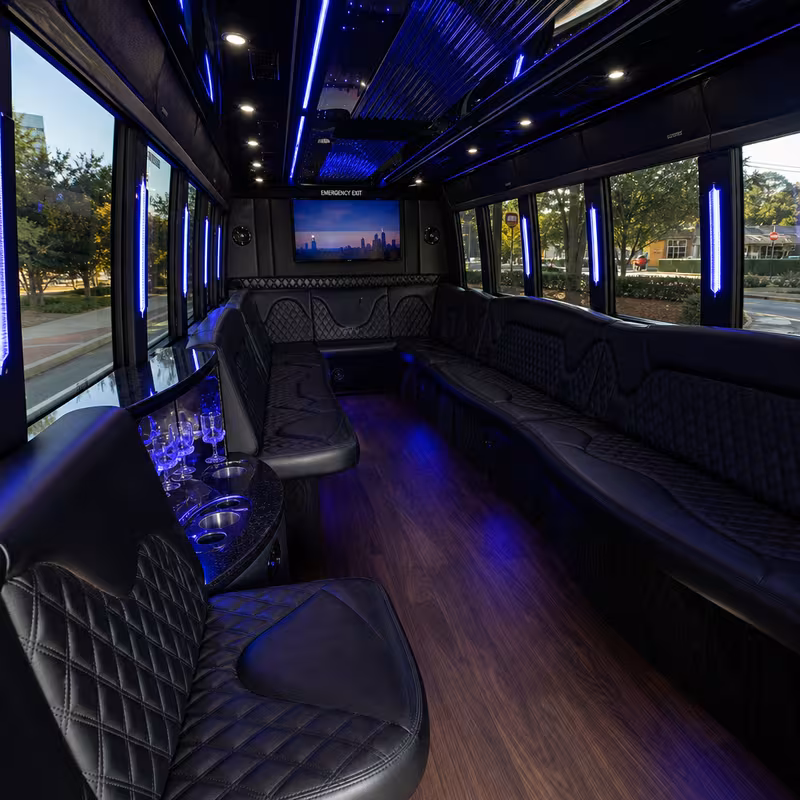 Party bus interior with wraparound leather seating and LED lighting in Atlanta