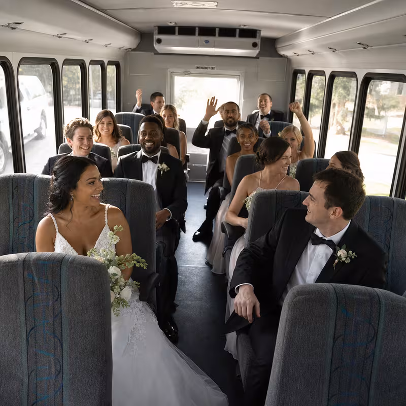 Group boarding a white charter bus for Wedding Transportation transportation in Atlanta