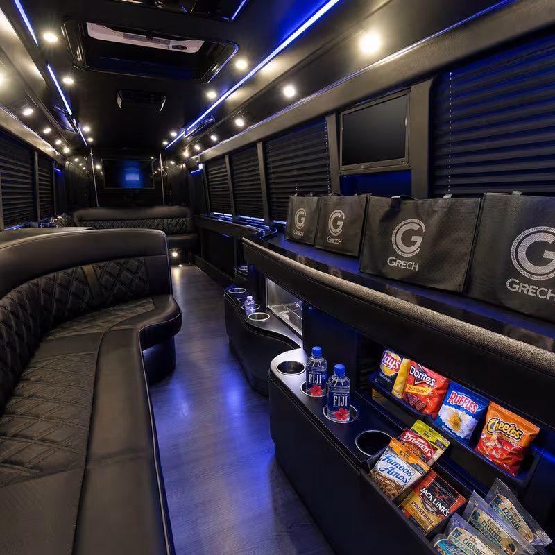 Party bus interior with wraparound leather seating and LED lighting in Atlanta